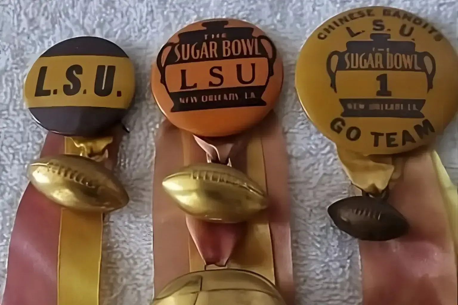 Sell vintage ticket stubs — Three vintage LSU Sugar Bowl football pinback ribbons with gold football charms